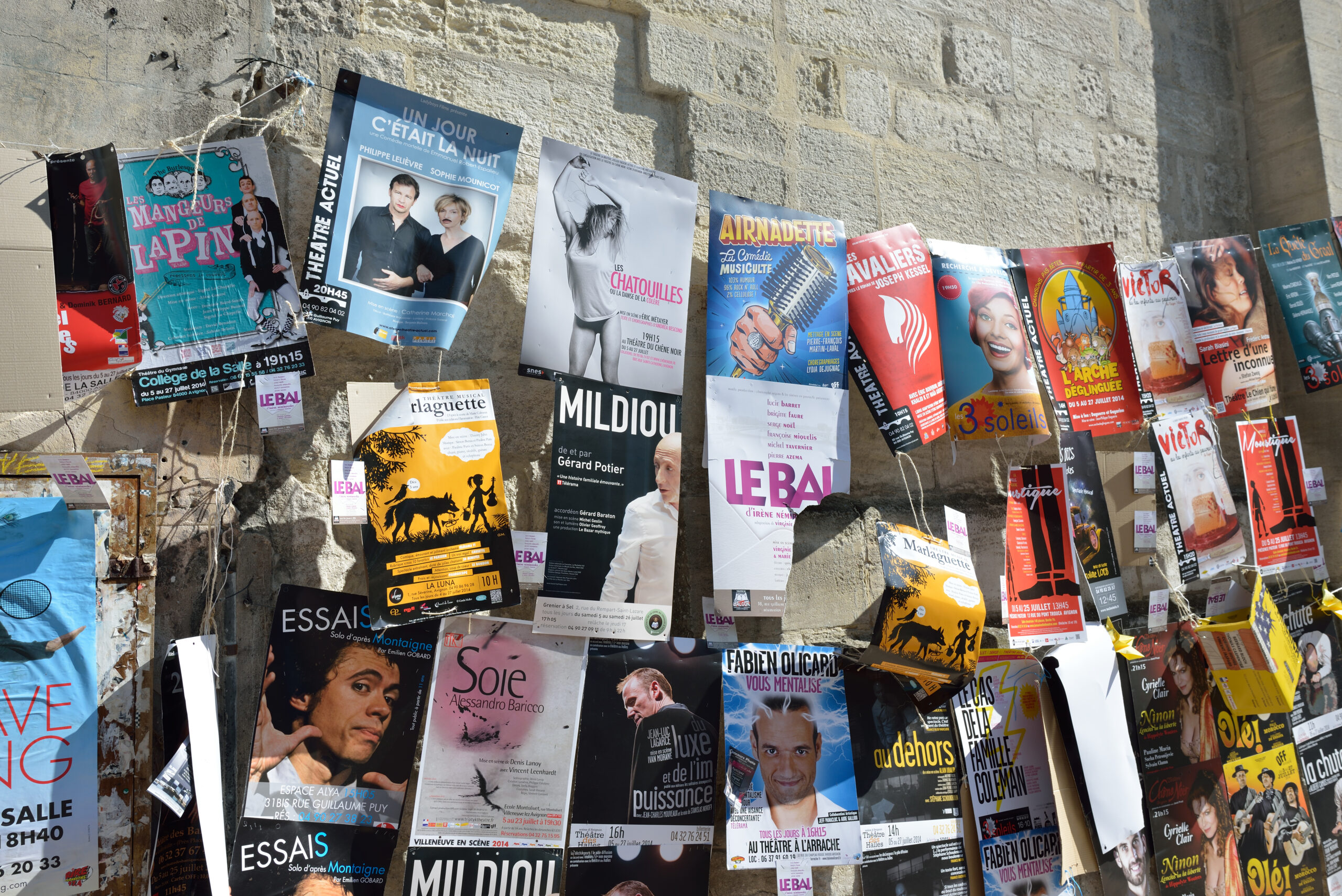 AVIGNON, FRANCE - JULY 12, 2014: Posters on the wall during annual Avignon Theater Festival, which in 2014 was attended around 500 theater companies in Avignon, France on July.